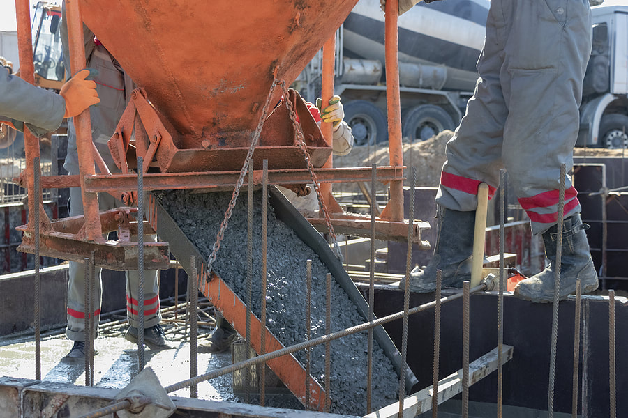 Workers pour concrete into the foundation at a construction site in Norwalk, CT.